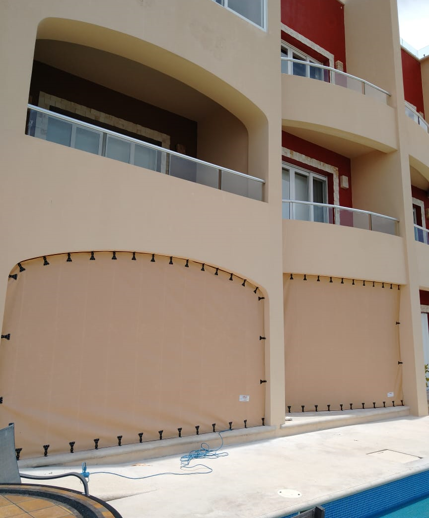 Hurricane Fabric vs. Accordion and Roll-Down Shutters in Los Cabos: An Oceanfront Owner’s Guide