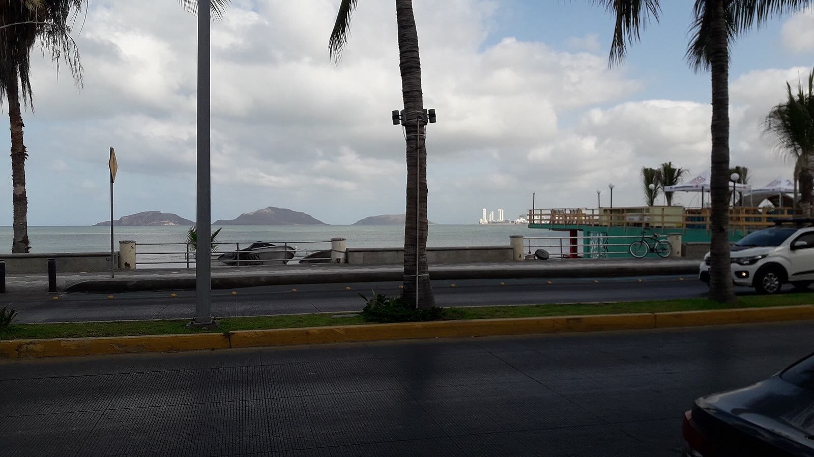 Mazatlán's seafront boulevard lined with palm trees on an overcast day