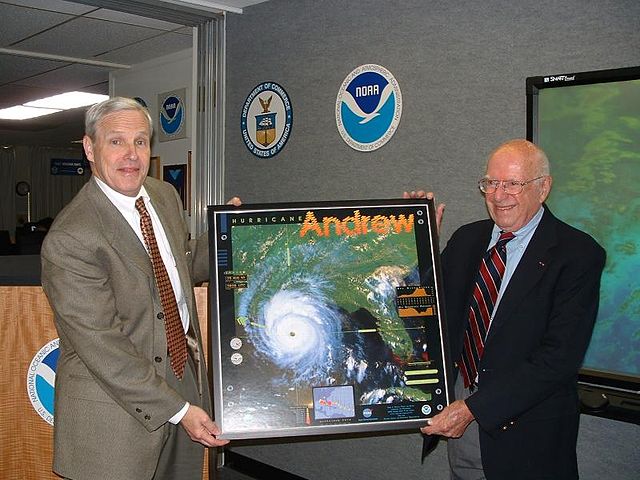 NWS Director Jack Kelly presents Herbert Saffir (on right) with a framed poster of Hurricane Andrew depicting the Saffir–Simpson scale